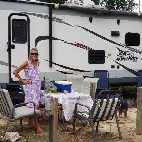 woman about to have lunch in front of her RV