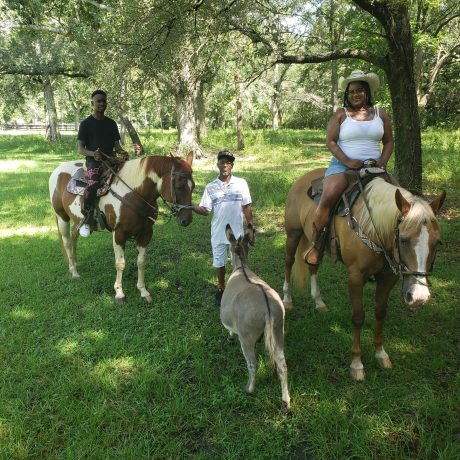 family taking horse riding lessons at Green Woods Stables RV Park